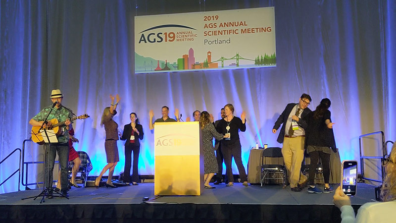 People singing on a stage at AGS19